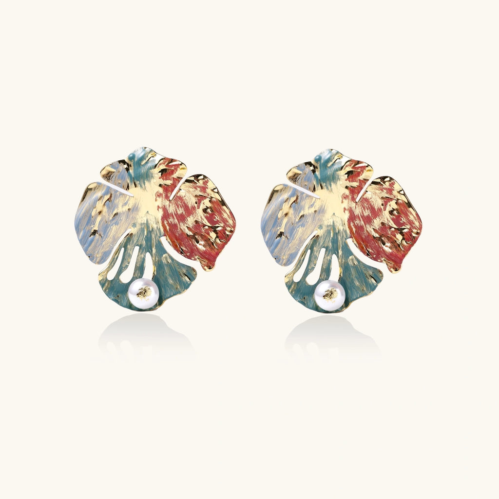 Front view of monstera leaf earrings with hand-painted enamel and pearl detail