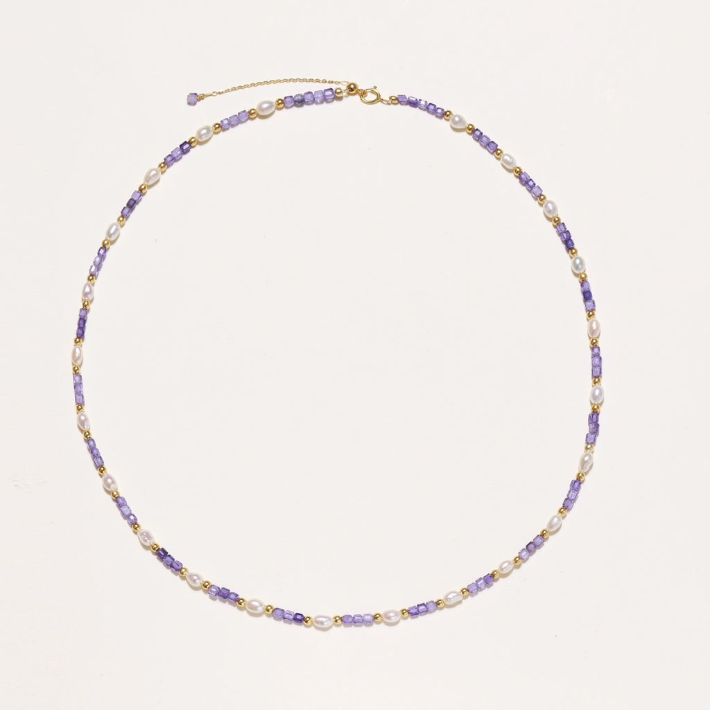 Close-up of lavender zirconia stones and freshwater pearls on gold vermeil necklace