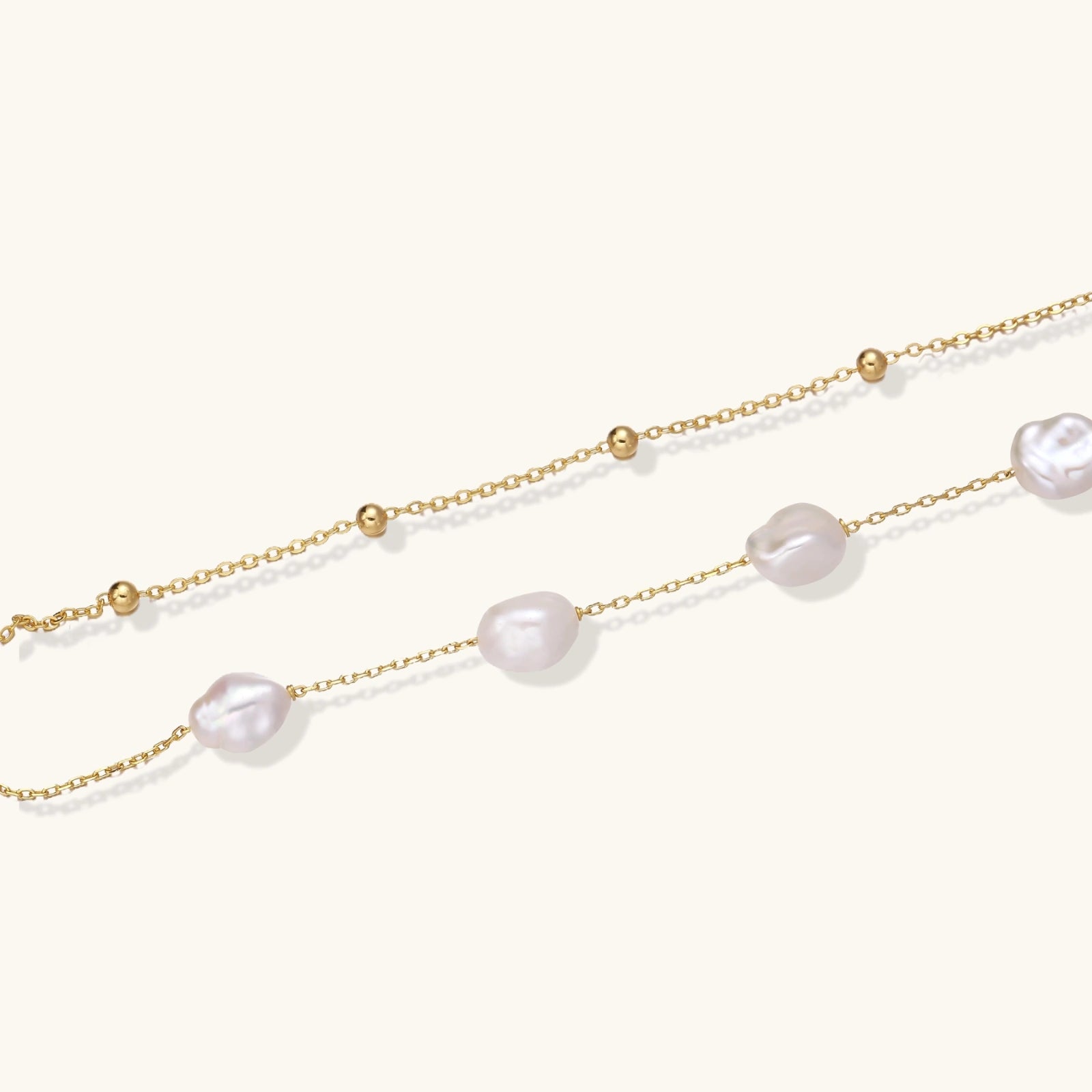 Close-up of baroque freshwater pearls on double gold vermeil chain bracelet