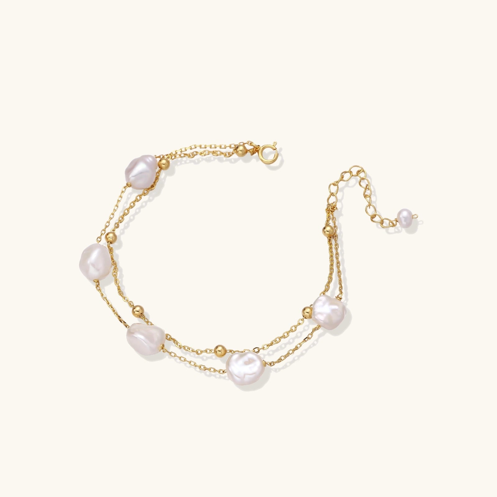 Flat lay of baroque pearl double chain bracelet on neutral surface