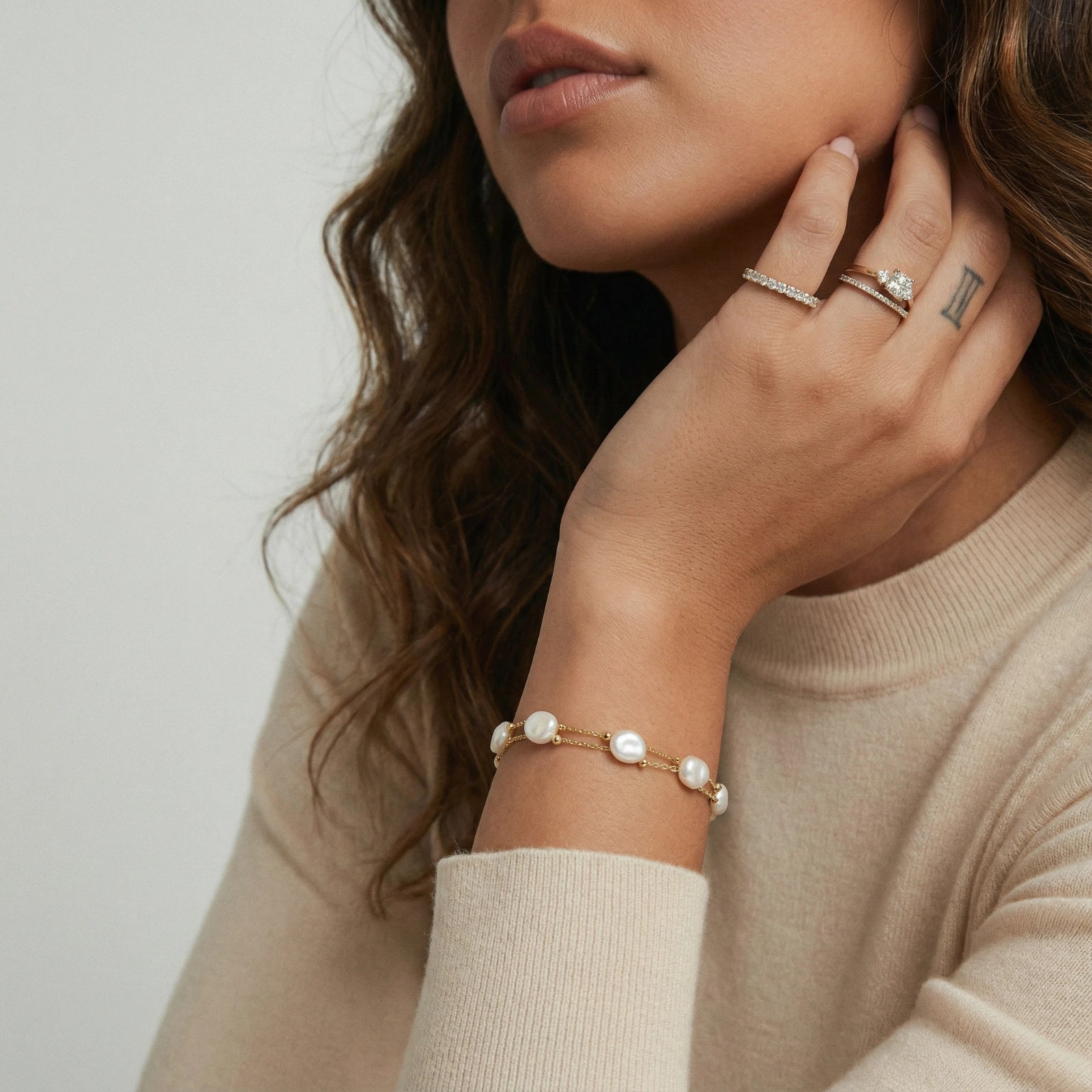 Model wearing GlacierFox Elements baroque pearl double chain bracelet in 18K gold vermeil