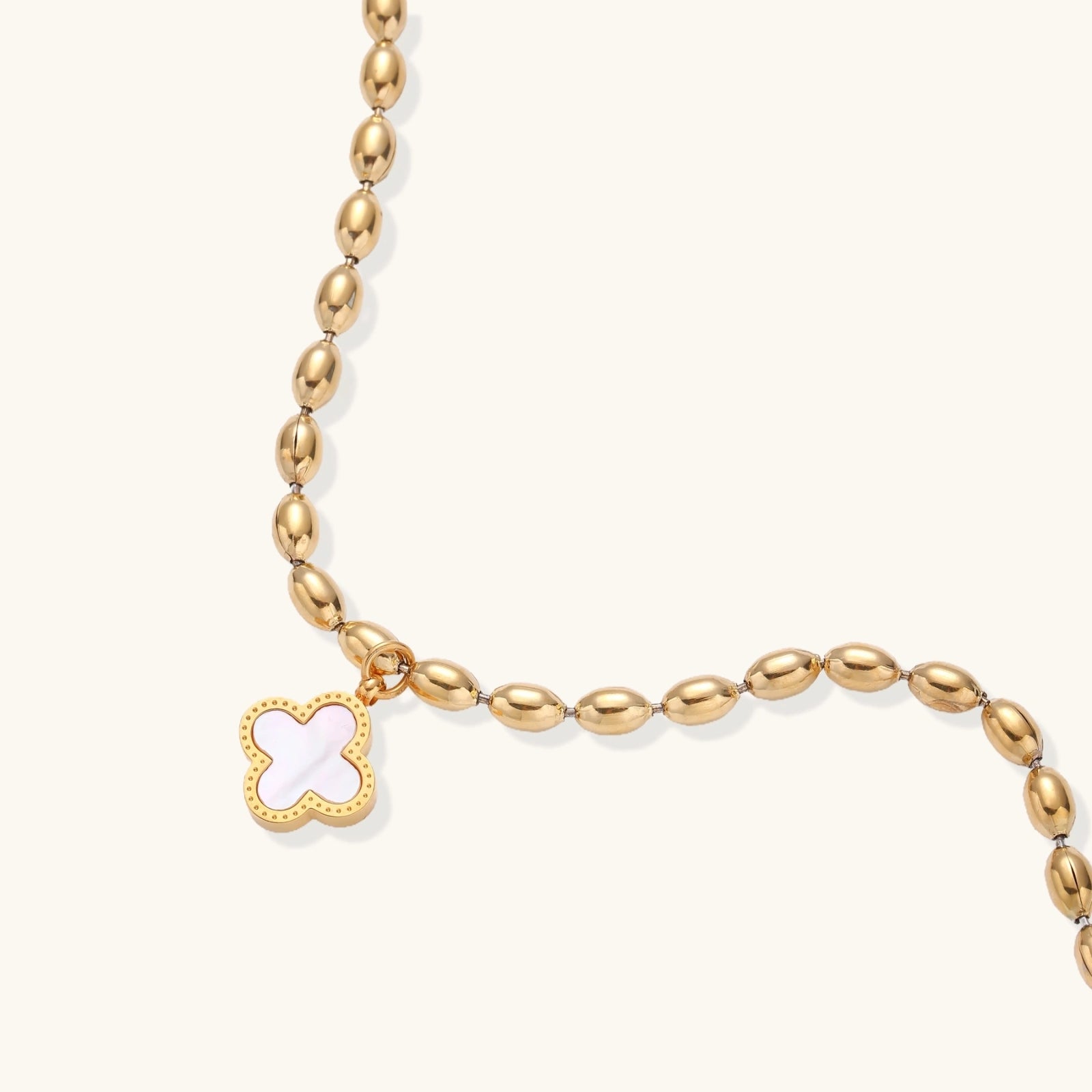 Front view of beaded bracelet with quatrefoil clover charm
