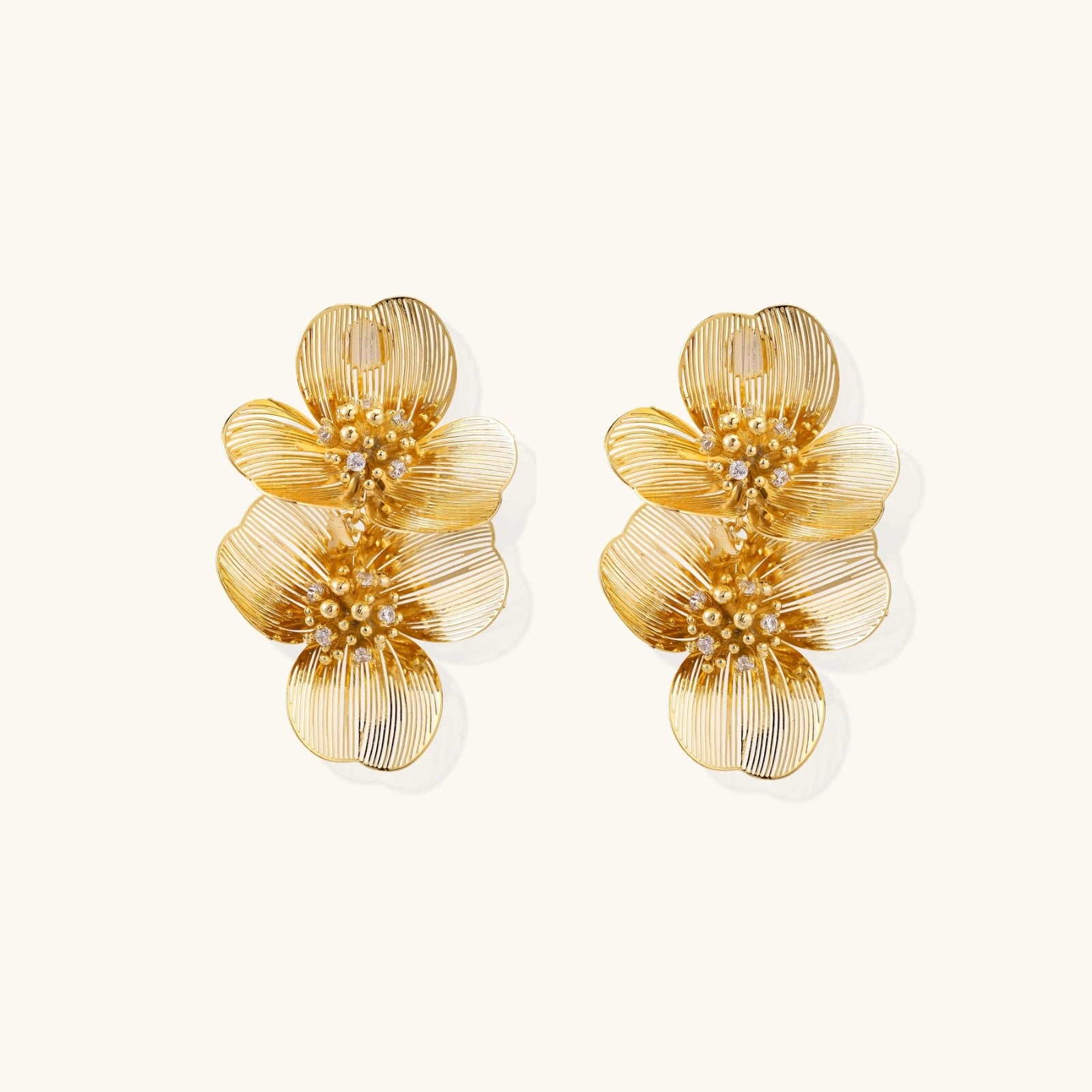 Angled product view of gold plated double bloom earrings