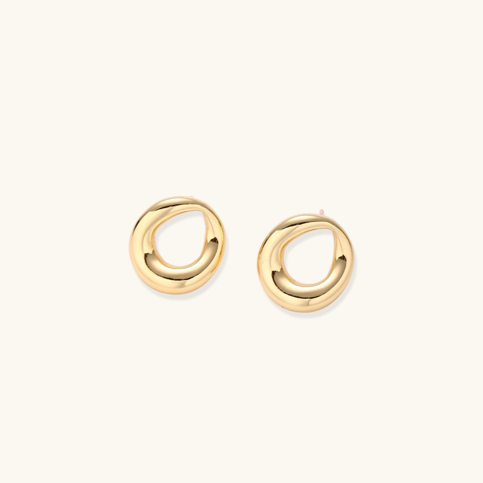 Front view of sculptural loop stud earrings with smooth gold finish