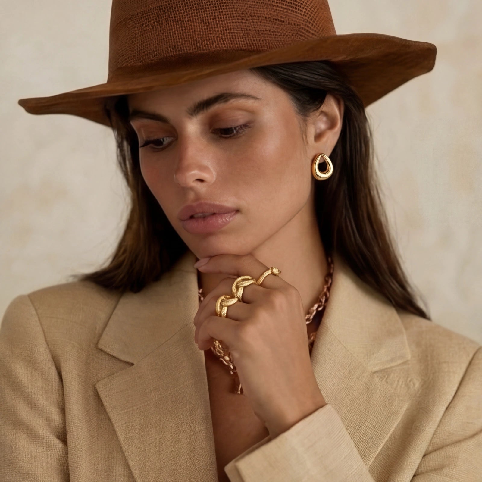 Model wearing GlacierFox Elements golden loop stud earrings in gold plated stainless steel