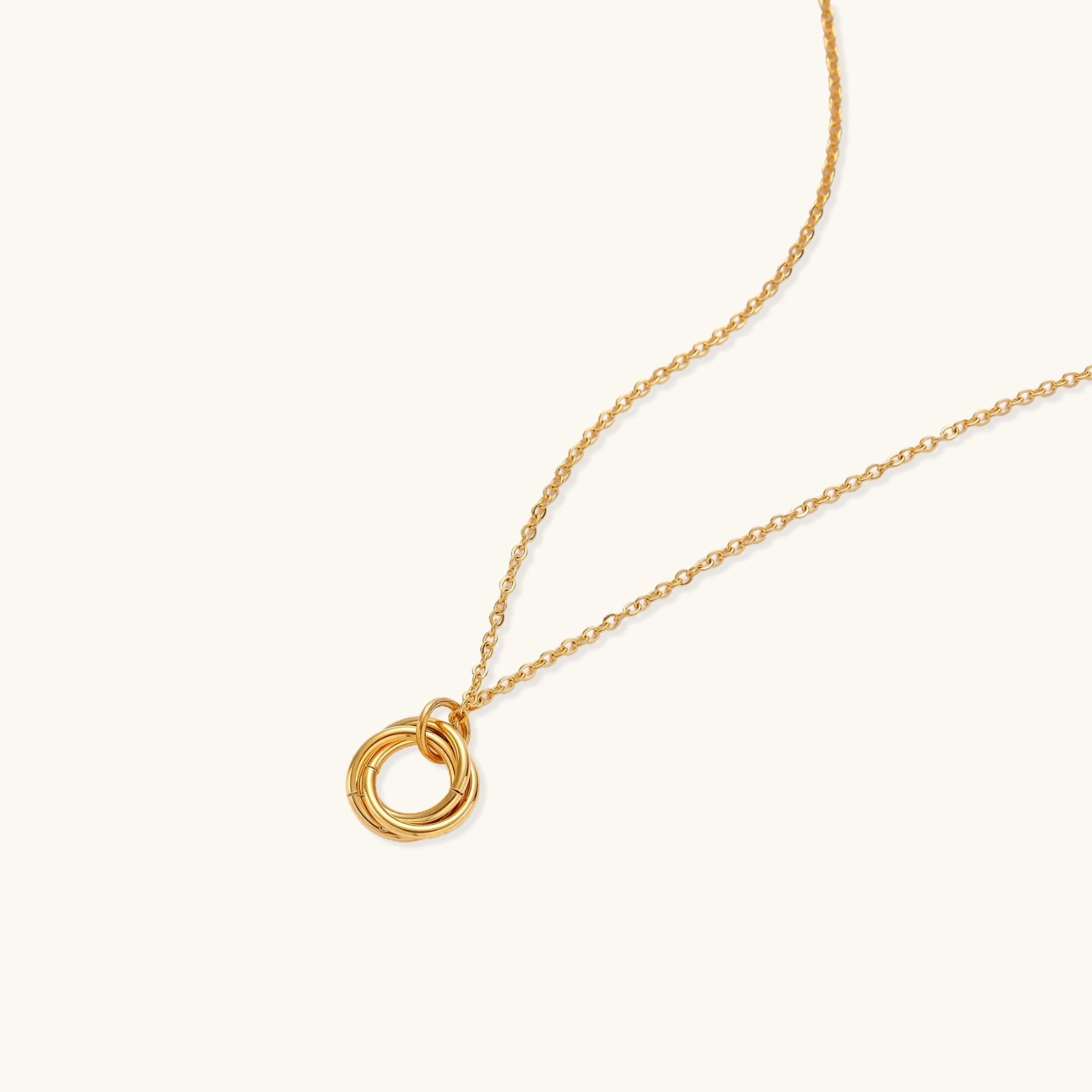 Close-up of gold plated interlocking circles on fine chain