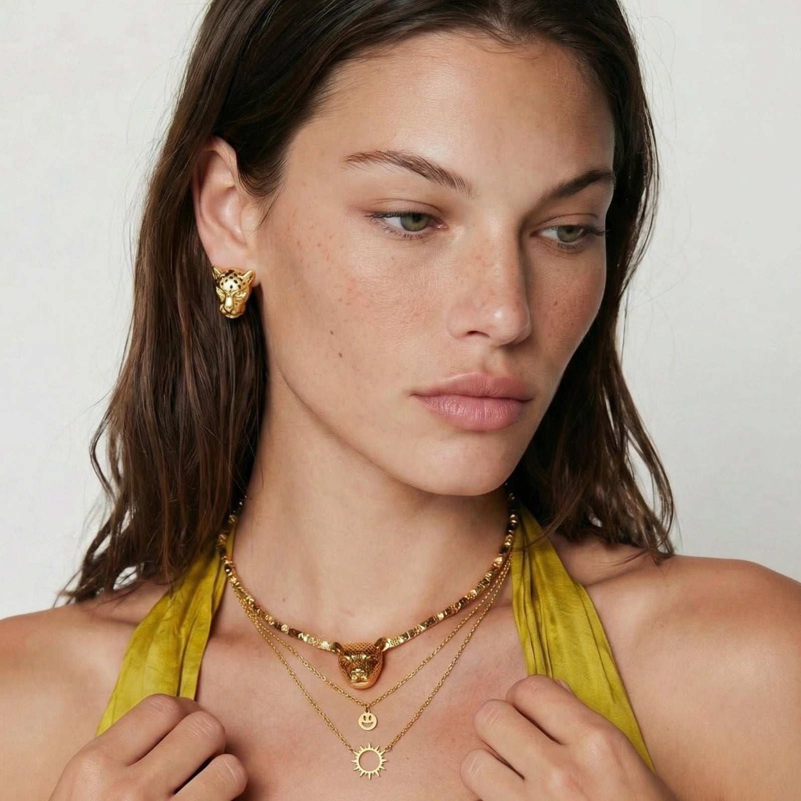 Model wearing GlacierFox Elements sunshine smiley layered necklace in gold plated stainless steel