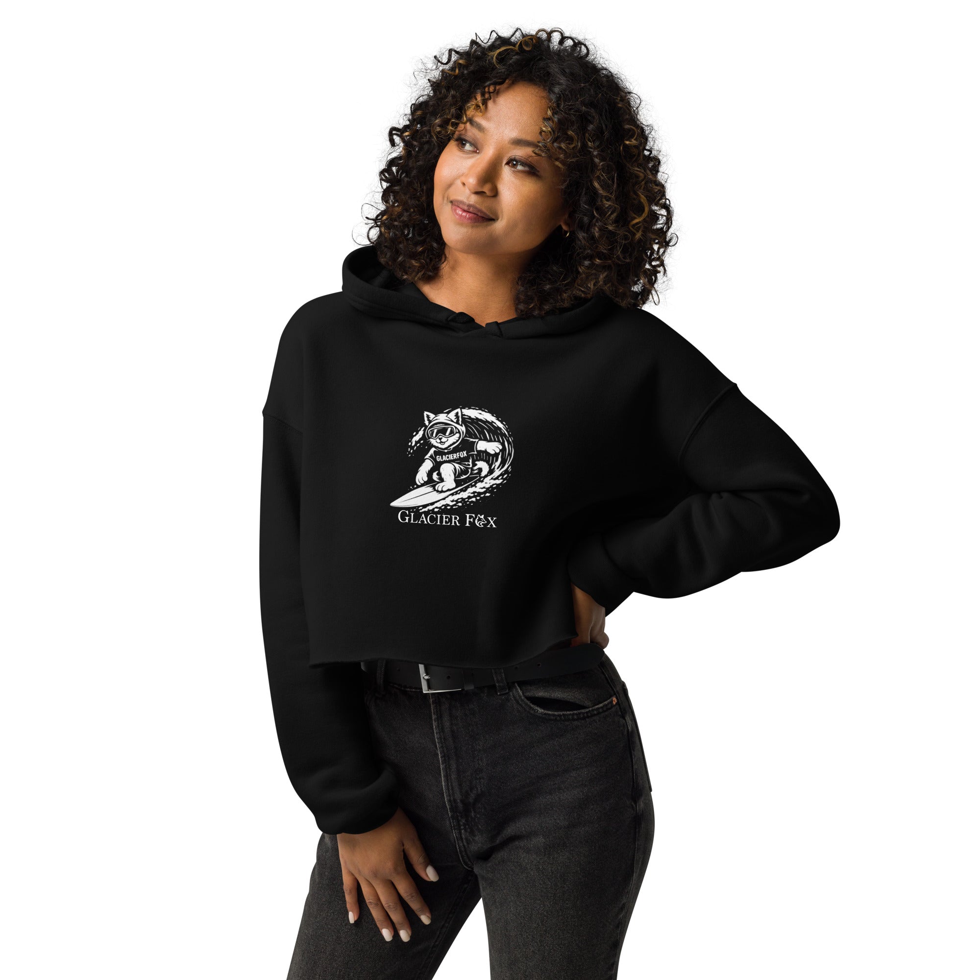Model wearing GlacierFox Surfing Gilbert women’s crop hoodie featuring the Gilbert the GlacierFox character design, cropped streetwear fit, and raw hem in Black
