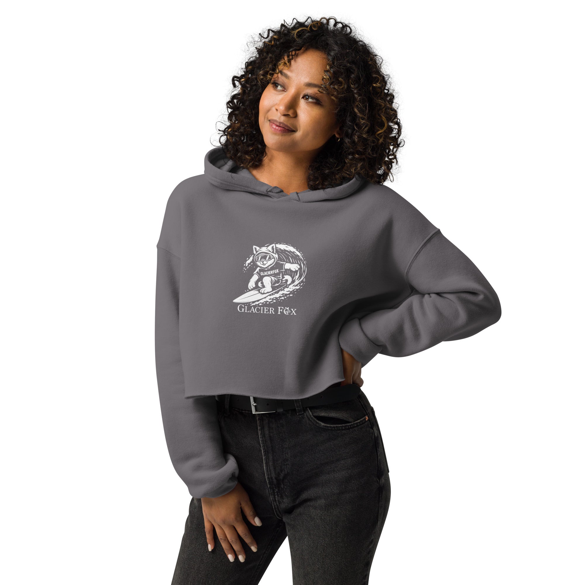Model wearing GlacierFox Surfing Gilbert women’s crop hoodie featuring the Gilbert the GlacierFox character design, cropped streetwear fit, and raw hem in Storm