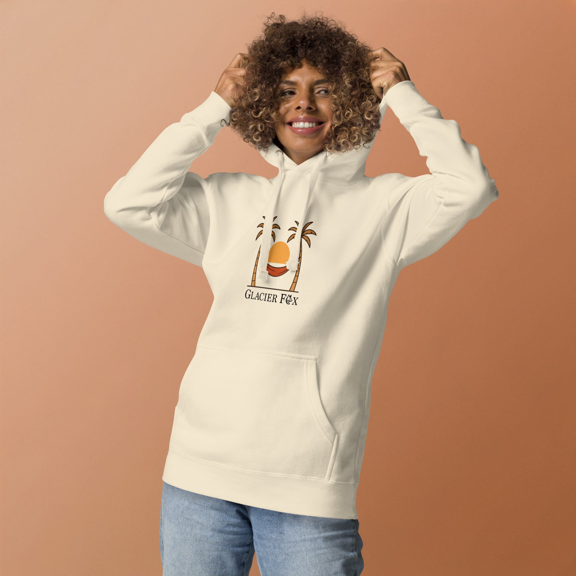 Model wearing GlacierFox women’s Sunset hoodie featuring a sunset design with the GlacierFox logo on the front and relaxed streetwear fit in Bone