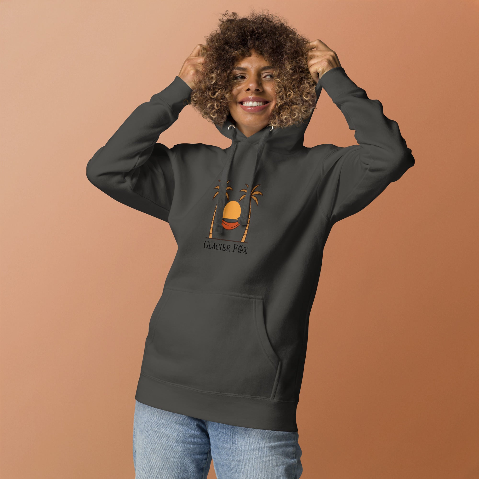 Model wearing GlacierFox women’s Sunset hoodie featuring a sunset design with the GlacierFox logo on the front and relaxed streetwear fit in Vintage Black