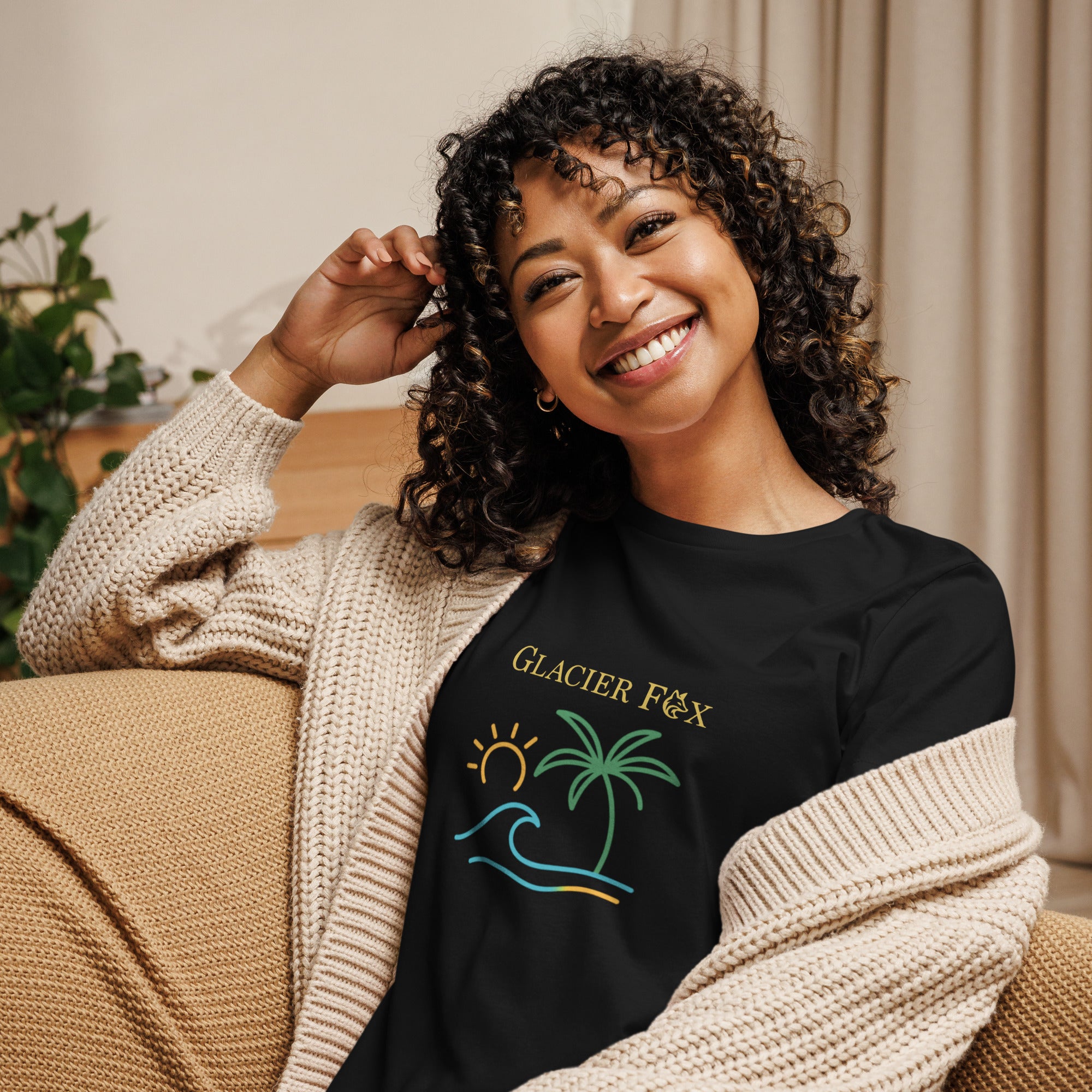 Model wearing GlacierFox women’s Waves t-shirt featuring a waves design with the GlacierFox logo on the front and relaxed streetwear fit in Black