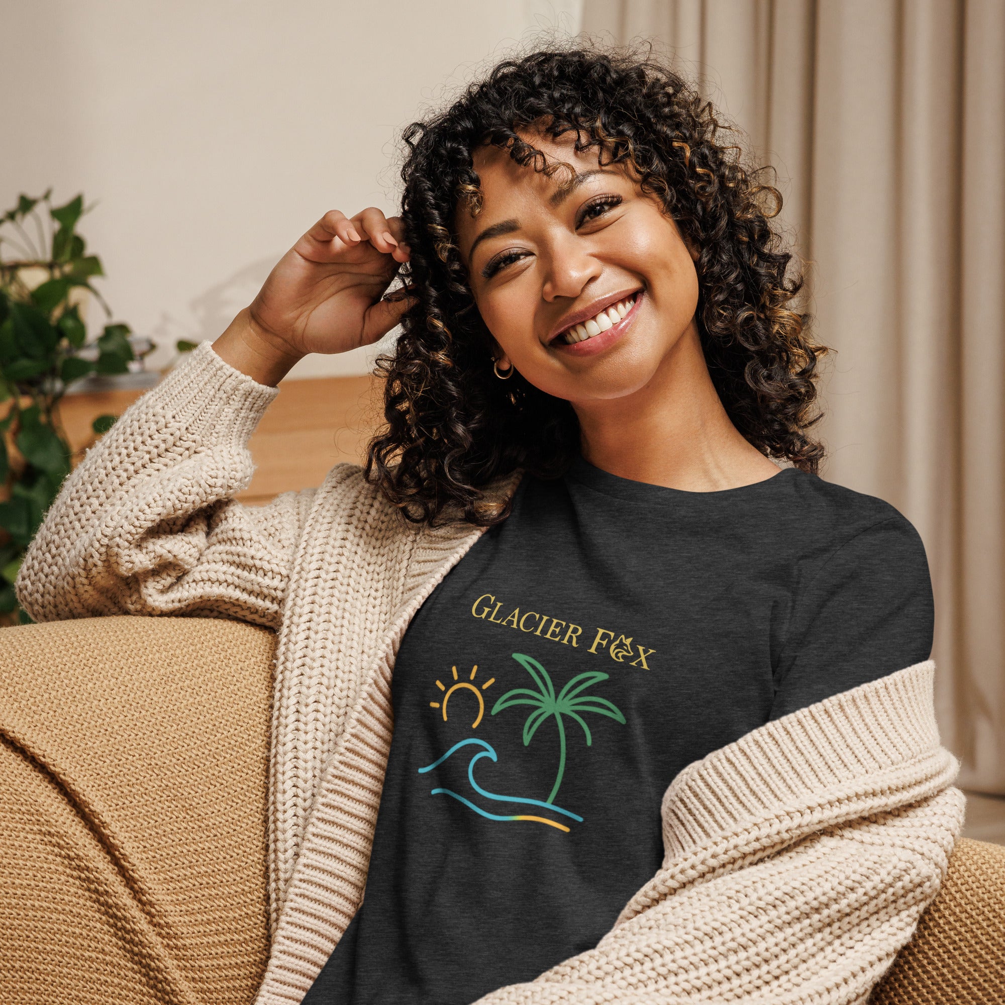 Model wearing GlacierFox women’s Waves t-shirt featuring a waves design with the GlacierFox logo on the front and relaxed streetwear fit in Grey Heather