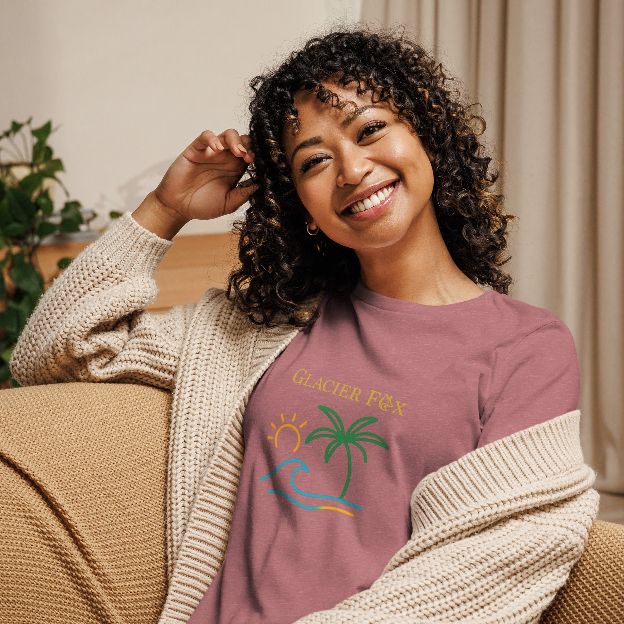 Model wearing GlacierFox women’s Waves t-shirt featuring a waves design with the GlacierFox logo on the front and relaxed streetwear fit in Heather Mauvre